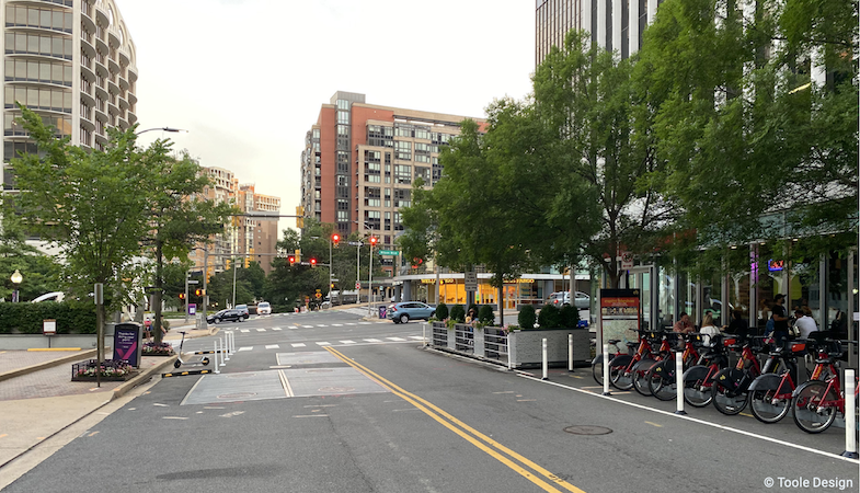 Image of a mobility hub in Rosslyn, Arlington County featuring parking spaces repurposed fora parklet and capital bikeshare station.